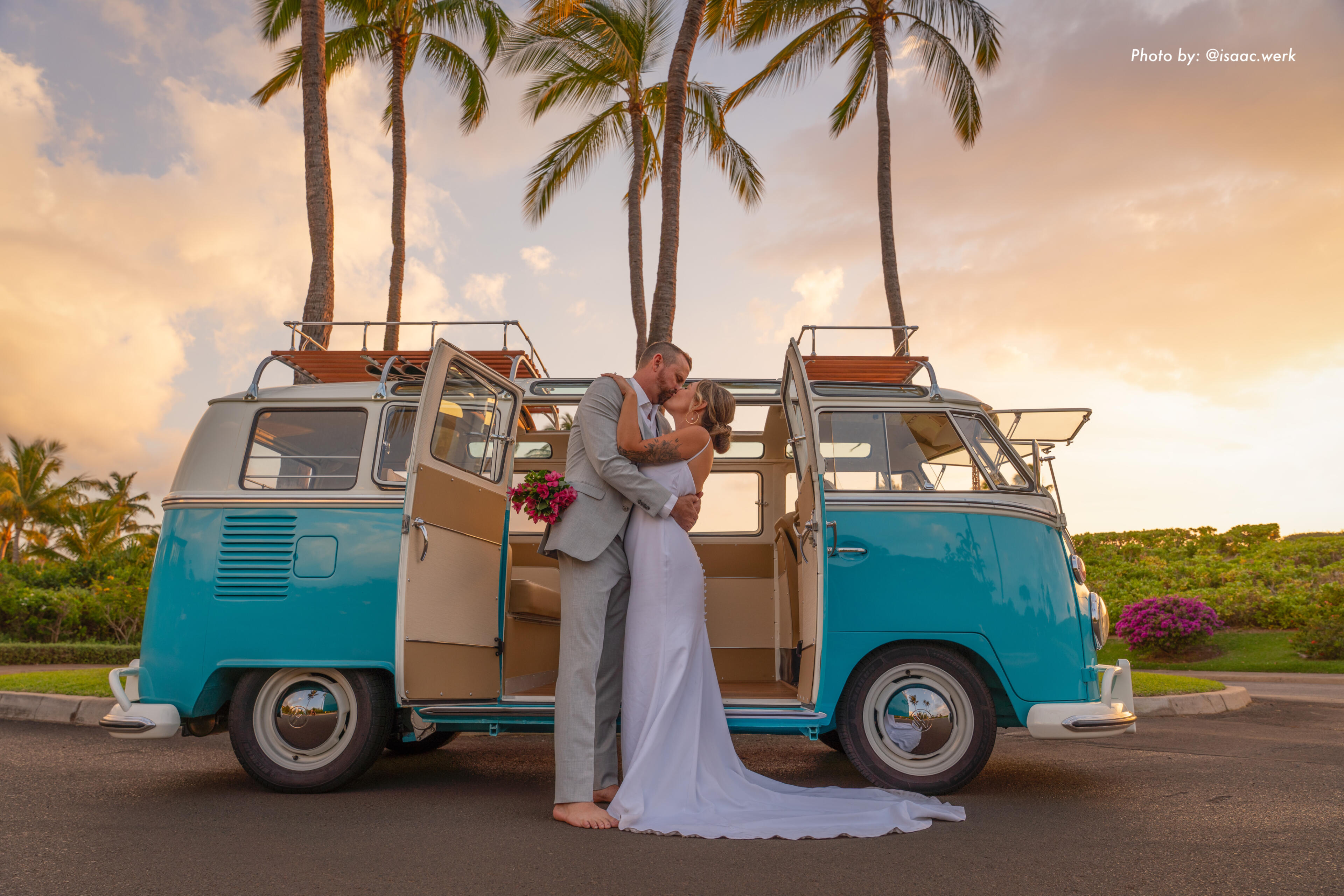 Couple kissing in front of a vintage VW bus during a Maui wedding photoshoot