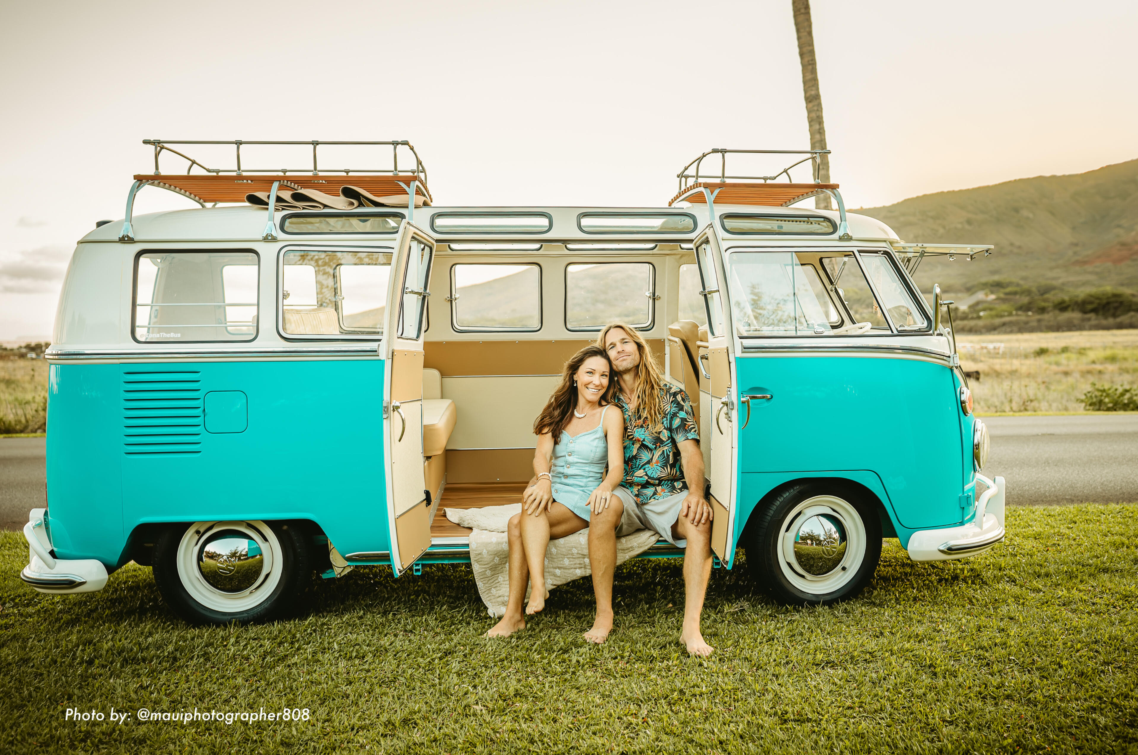 Couple sitting in a restored 1967 VW 21-window bus on Maui