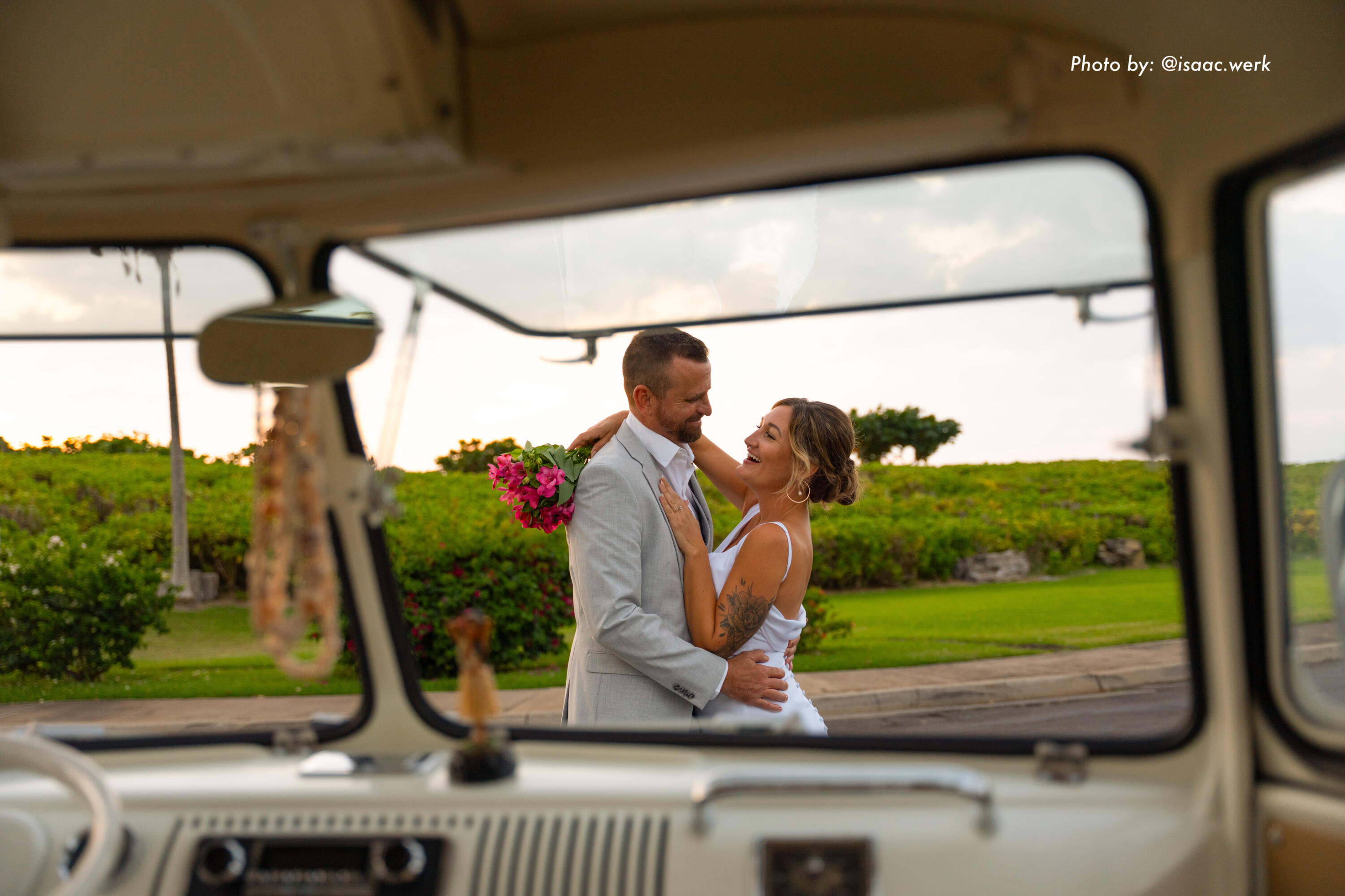 Bride and groom posing during a vintage VW bus wedding photoshoot on Maui